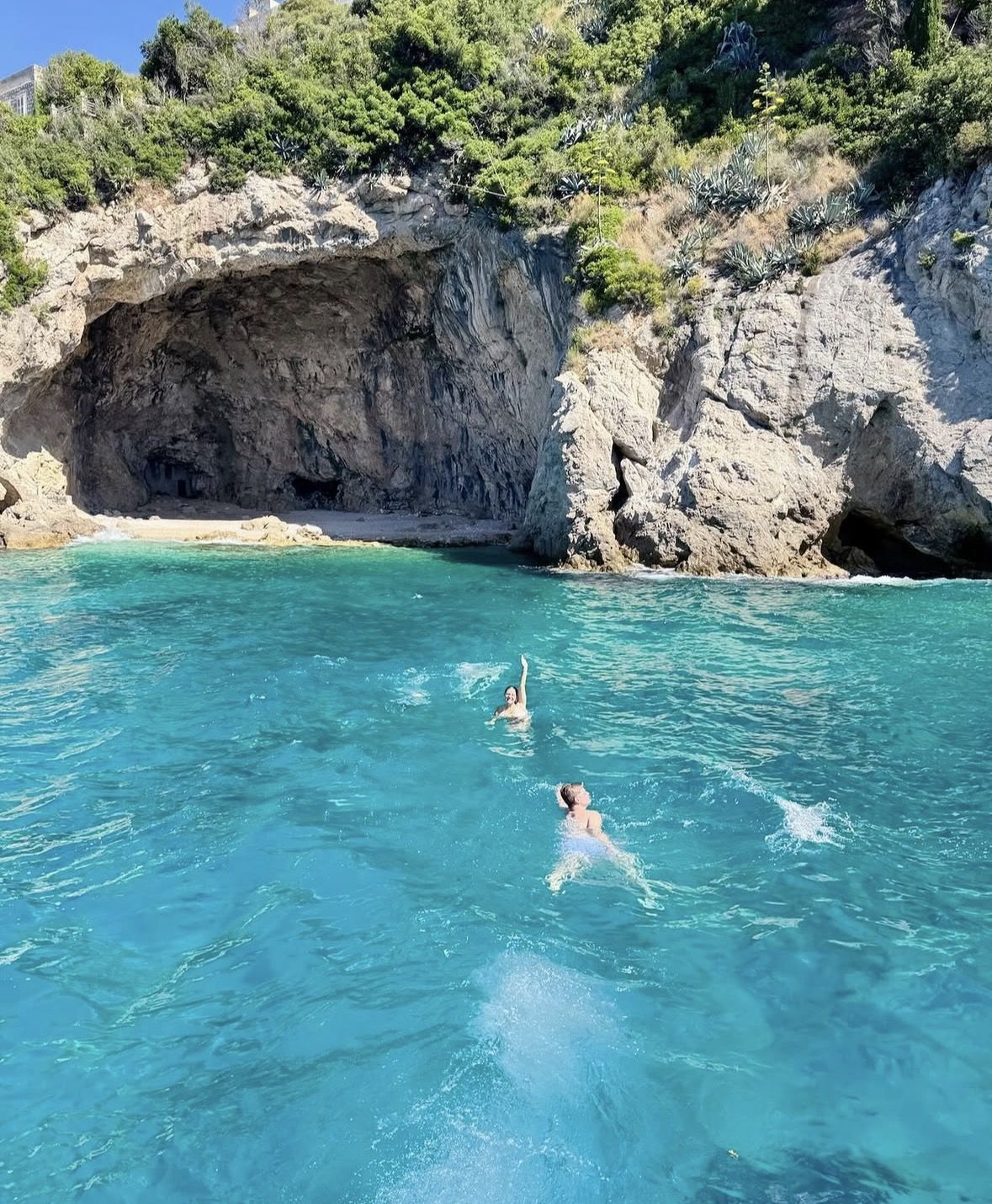 Snorkelling gear, sunscreen, and a dry bag laid out on a boat deck ready for a Dubrovnik sea cave tour